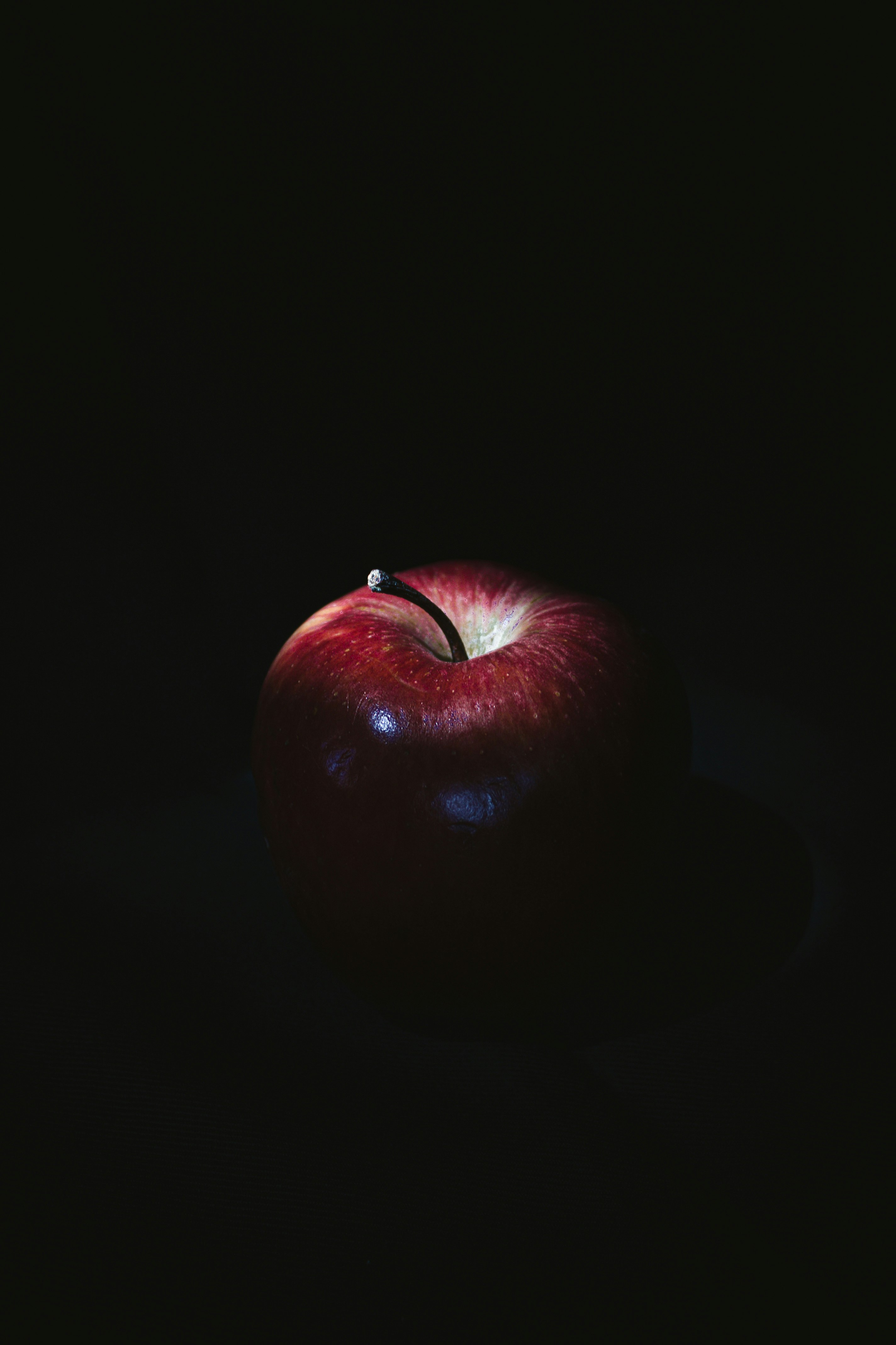 red apple on black surface